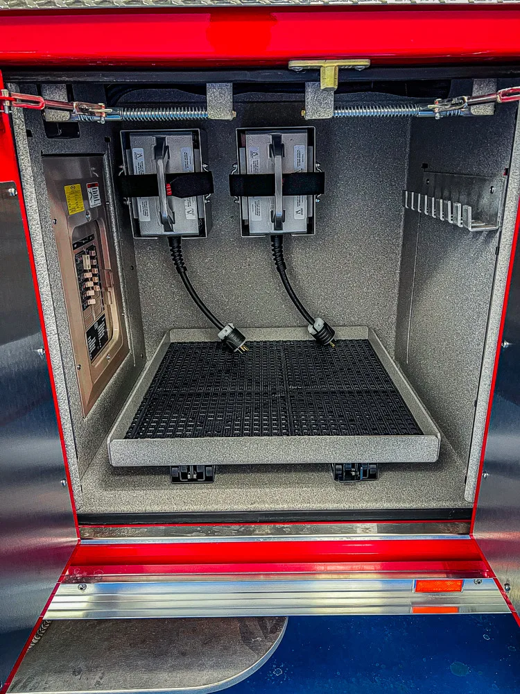 Open lower body compartment showing an empty storage bay and mounting points
