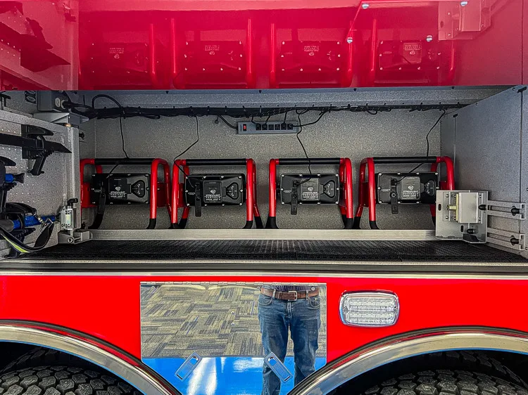 Open long side compartment showing mounting brackets and equipment channel space