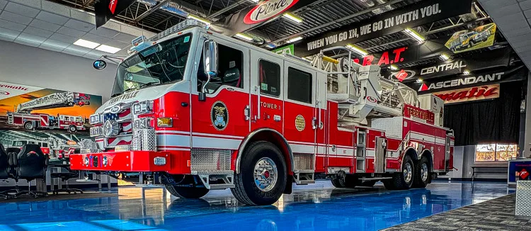 Front-right exterior view showing cab corner, bumper, and side body