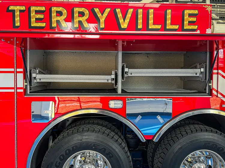 Side body close-up showing upper lettering panel and tandem rear wheel area