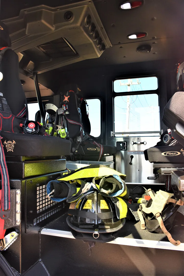 Cab interior view showing front seats, center aisle, and dashboard area