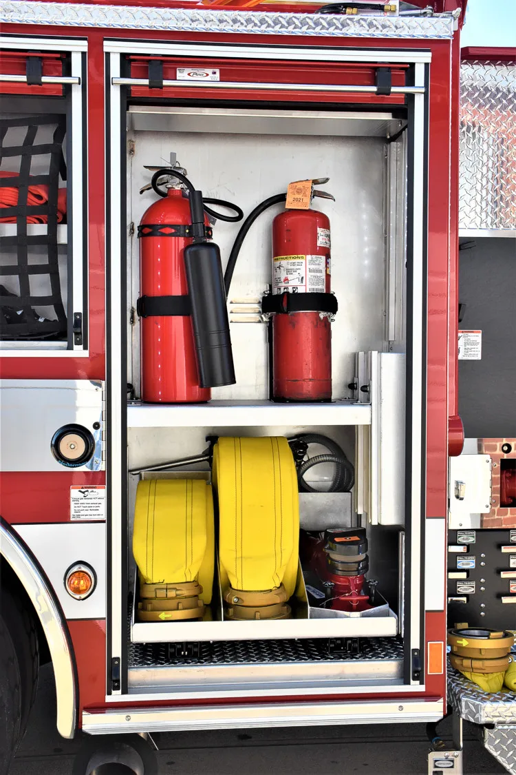 Open side compartment showing mounted extinguishers and yellow air cylinder
