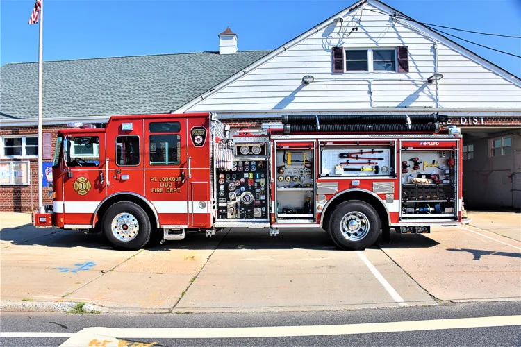 Driver-side profile view with open compartments showing tools and equipment trays