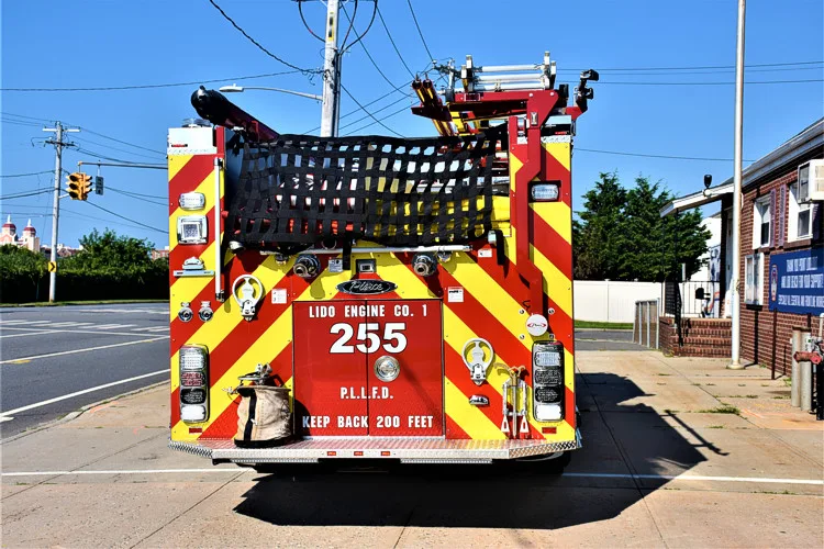 Rear view showing red-and-yellow chevrons and hosebed area