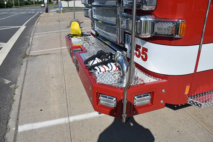 Front bumper corner close-up showing intake connection and warning light