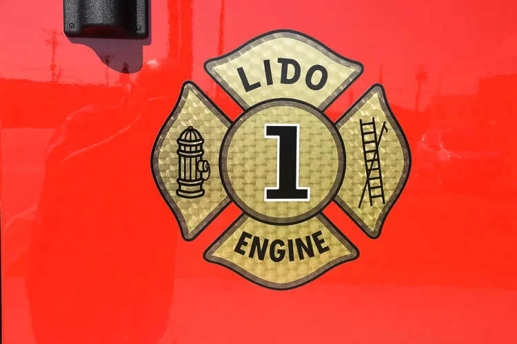 Cab door close-up showing a Maltese-cross style badge on red panel