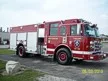 Wide front-right thumbnail view of the pumper parked roadside with full side profile visible.