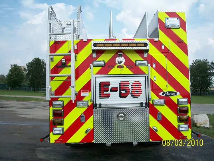 Straight rear view with red-yellow chevrons, rear fittings, and center rear roll-up door.