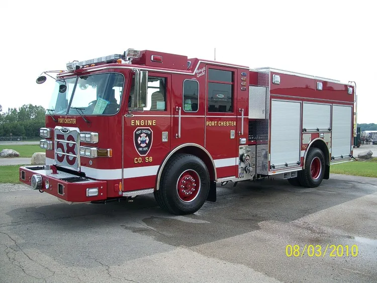 Front-right wide view showing the pumper cab face, side compartments, and rear body section.