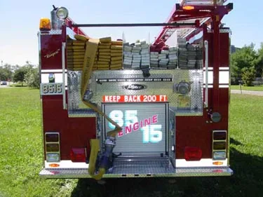 Rear view showing hose stacks in hosebed and rear warning lights