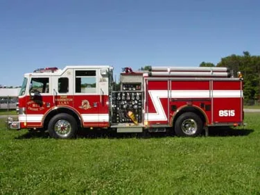 Driver-side profile view showing pump panel area and side compartments