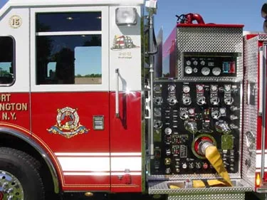Pump panel close-up showing gauges, valves, and hose connection