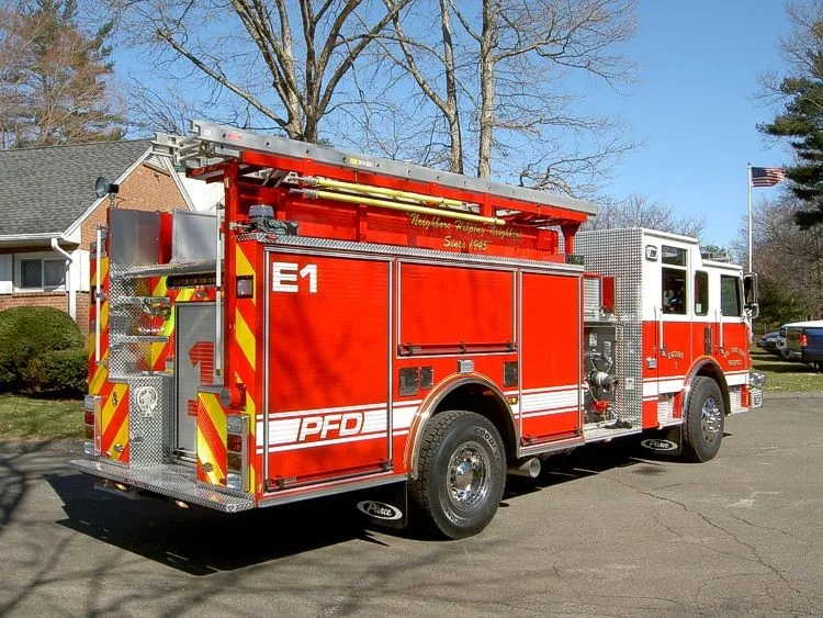 Rear-right exterior view showing side hosebed rails and rear body panel