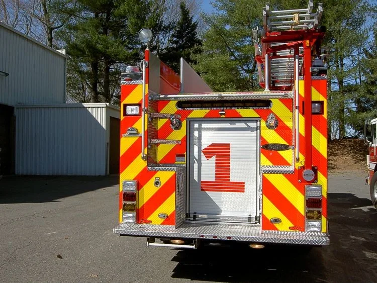 Rear view showing chevron striping, rear door panel, and warning lights