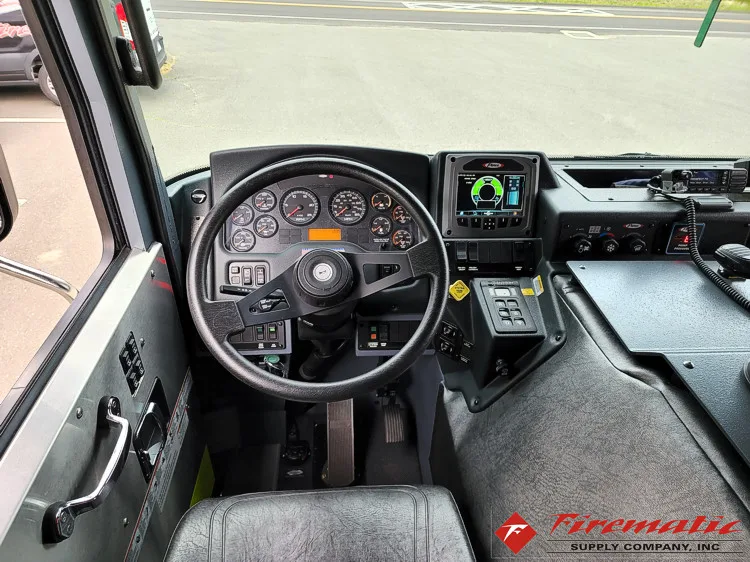 Driver cockpit view showing steering wheel, dashboard, and center controls