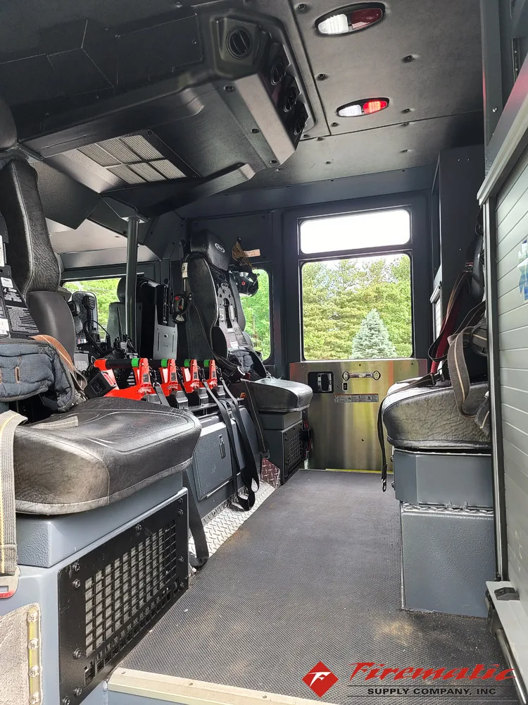 Cab interior side view showing rear seating and equipment cabinet area