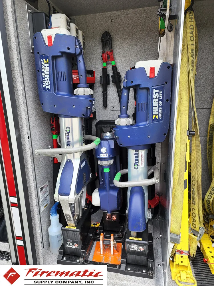 Open narrow compartment showing mounted long tools and straps