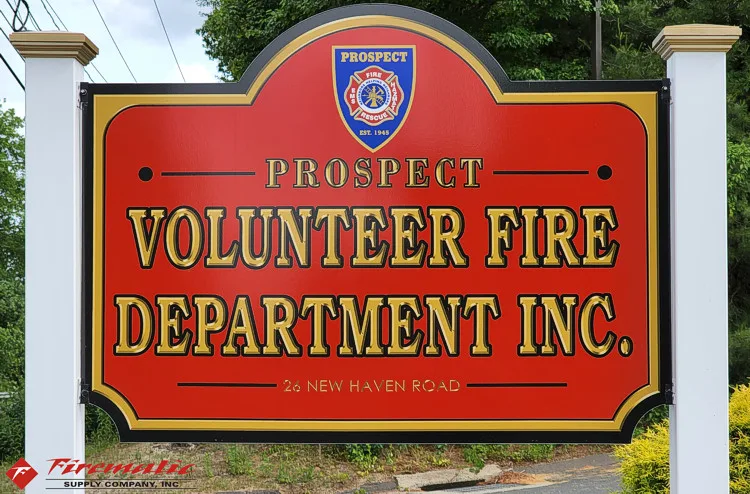 Roadside sign close-up showing volunteer fire department lettering