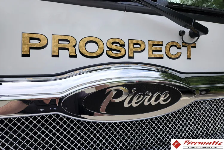 Front grille close-up showing raised script and Pierce emblem