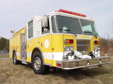 Pumper front-left view with grille, front wheel, and side body compartments