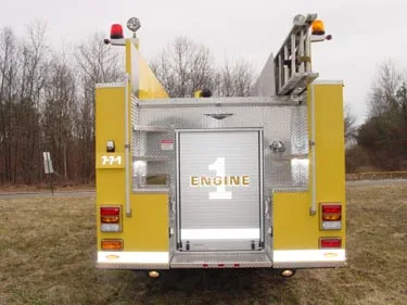 Rear view showing roll-up rear door, upper ladders, and rear warning lights