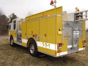 Rear-right exterior view showing rear compartment, side compartments, and ladder rack
