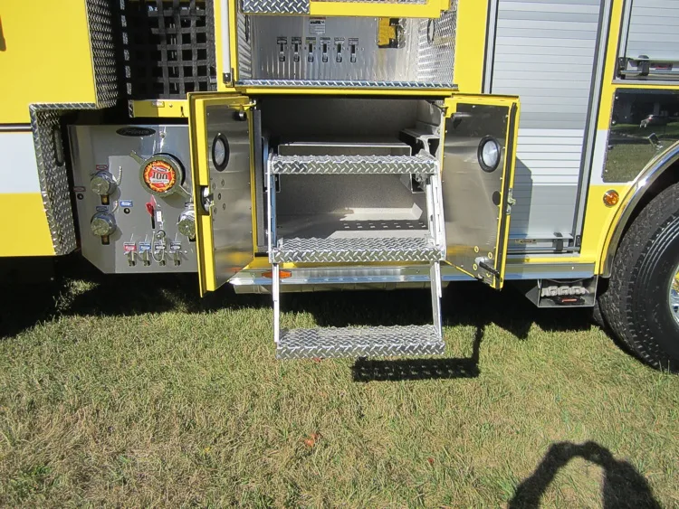 Open side compartment showing fold-down step tray and interior storage bay