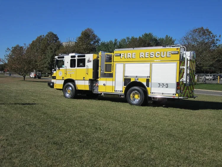 Driver-side full profile view showing long rescue body and wheelbase