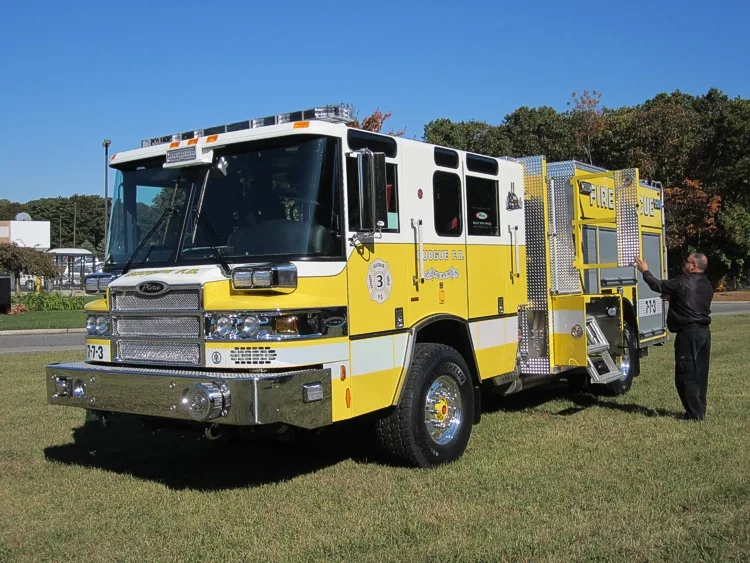 Front-left exterior view with person standing beside open side door