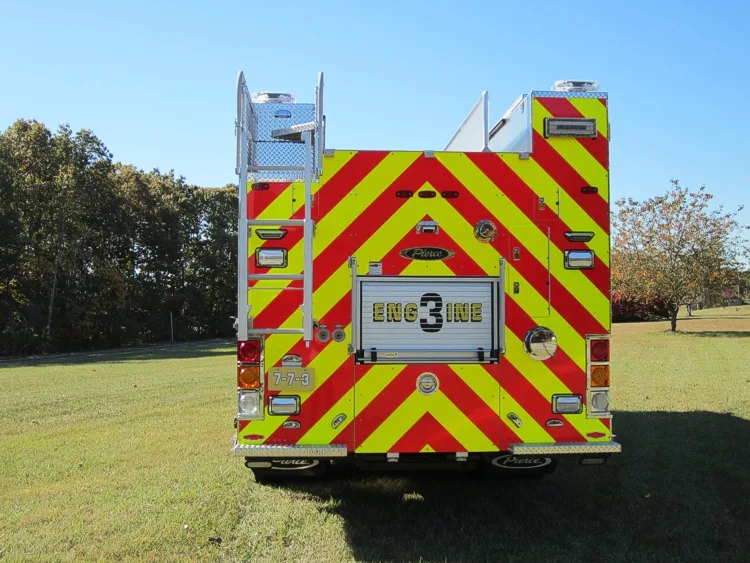 Rear view showing red-and-yellow chevrons and center rear unit panel