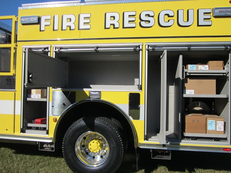 Side compartment close-up showing empty shelf space and rear wheel area