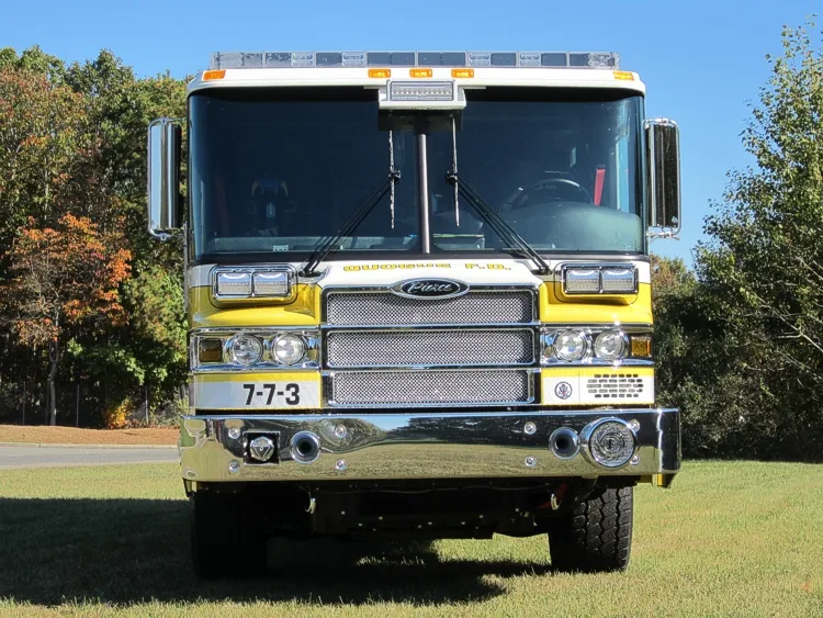 Head-on front view showing grille, bumper, and warning lights