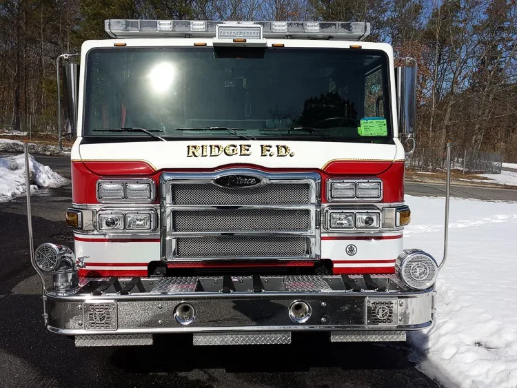 Head-on front view showing windshield, chrome grille, warning lights, and front intake ports.