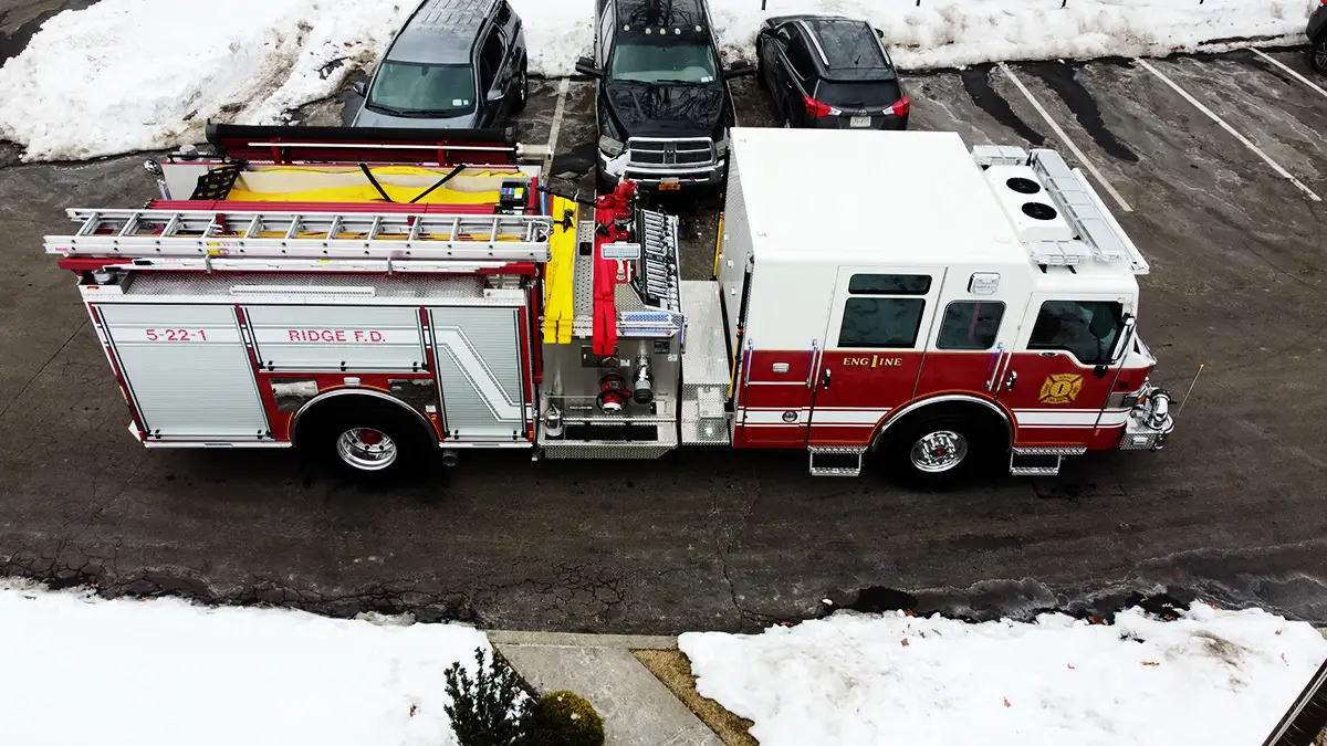 Aerial top-down side view showing full apparatus length and compartment layout