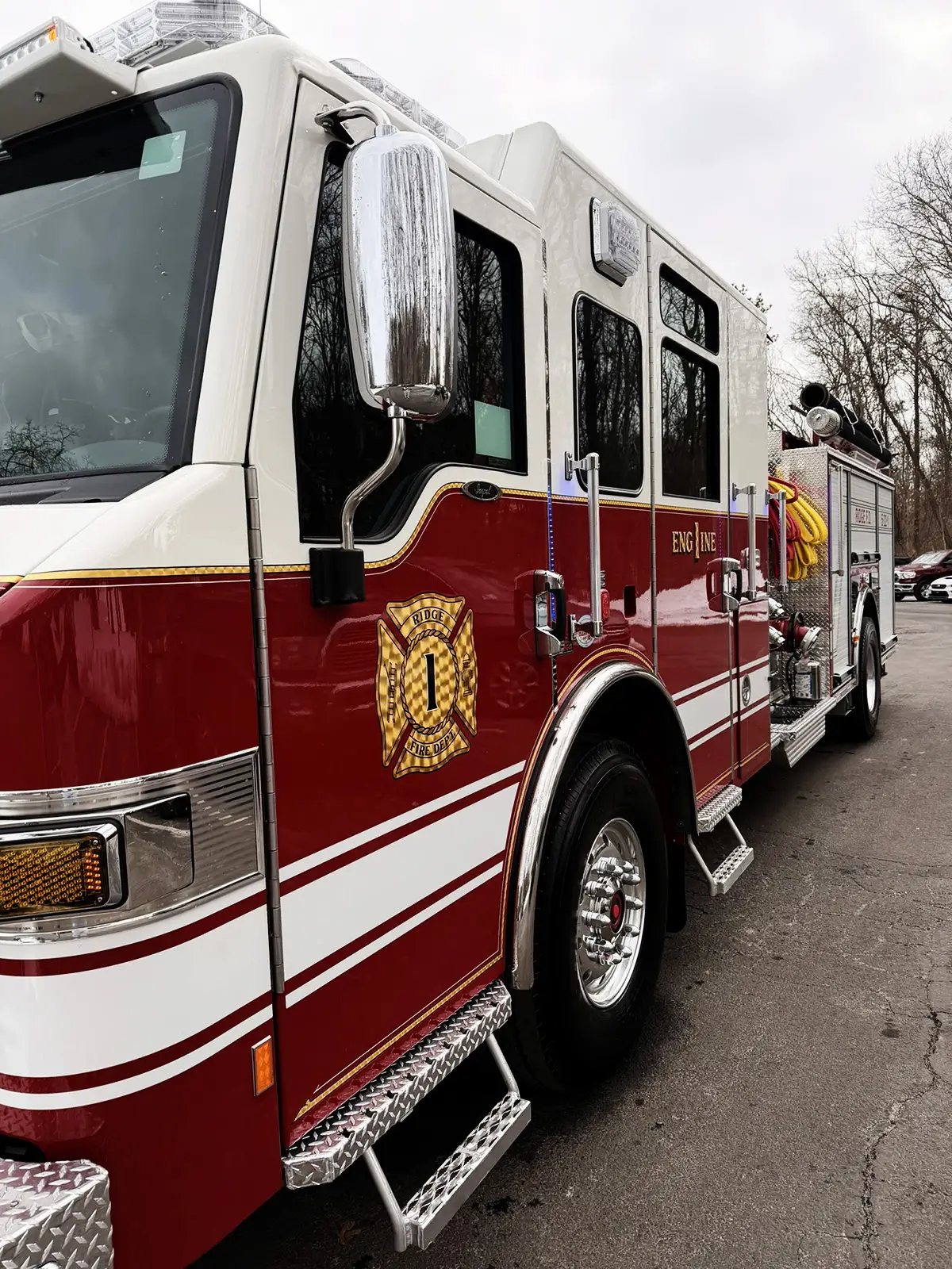 Cab-side close-up showing chrome Pierce badge on red body panel