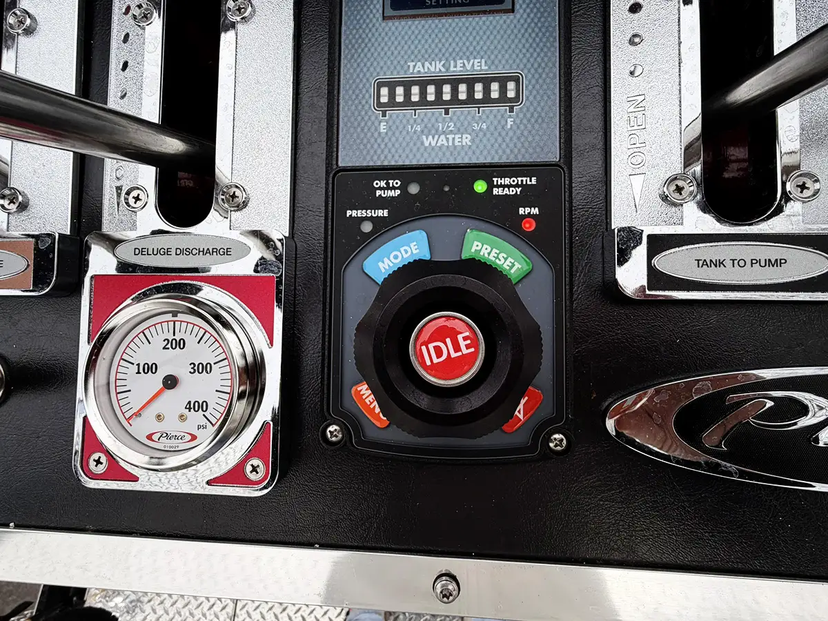 Rear view showing red-and-yellow chevrons, rear lights, and open center bay