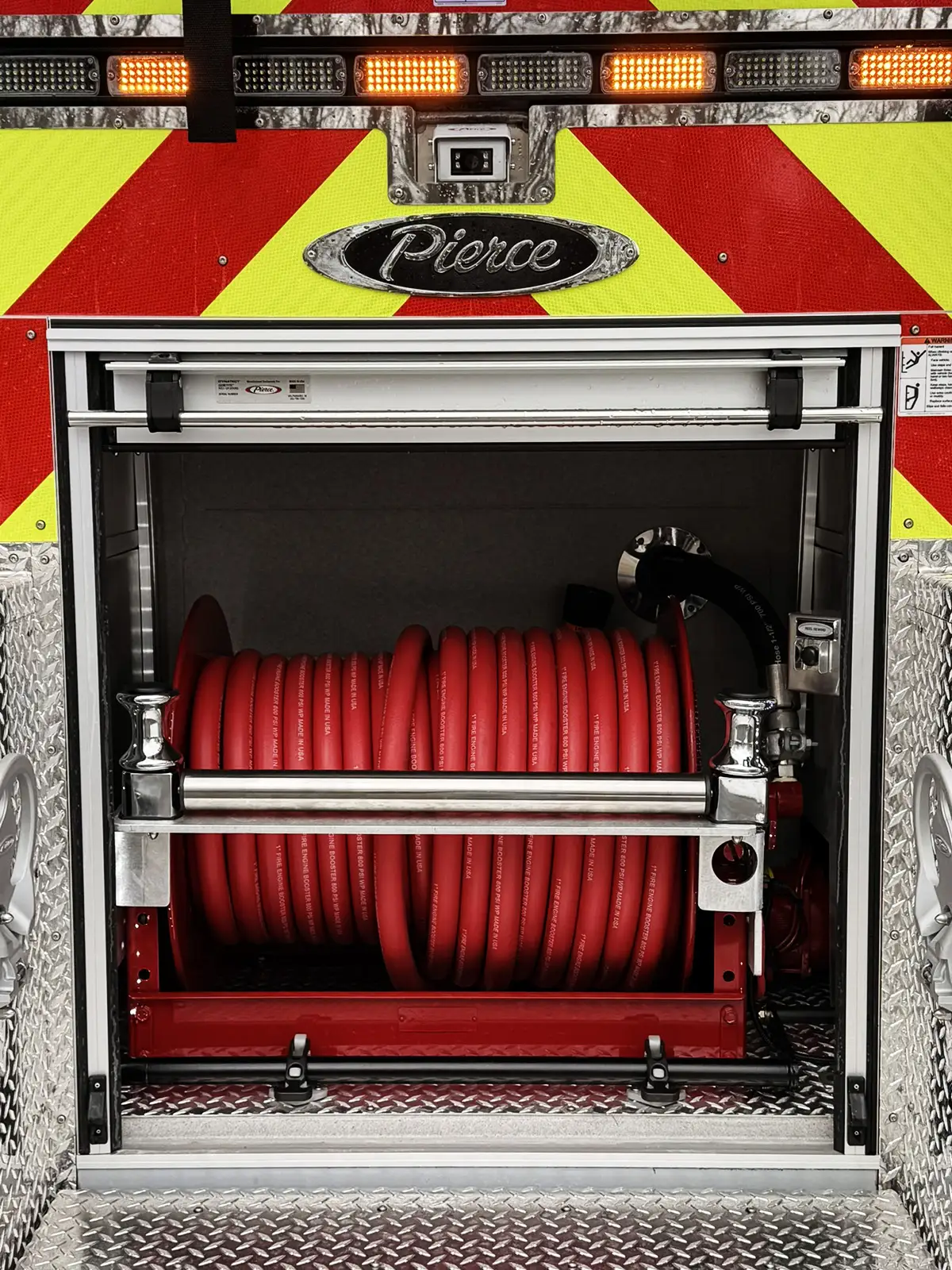 Front bumper corner close-up showing mounted bracket and reflective striping