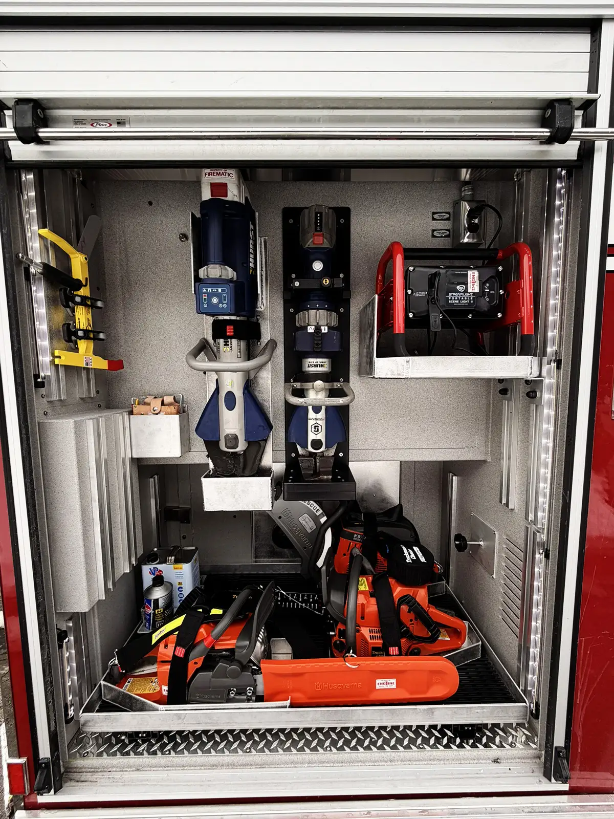 Open side compartment showing pull-out tray with mounted hand tools