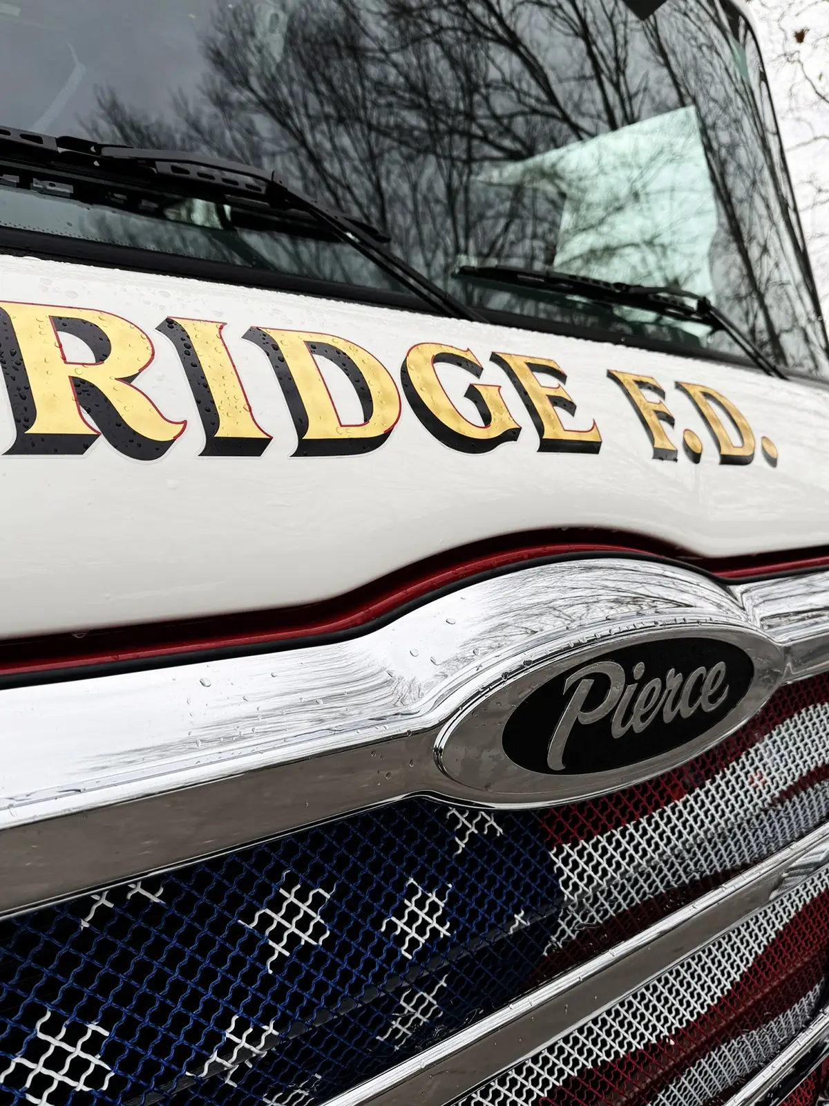 Front bumper light housing close-up with chrome ring and amber lens