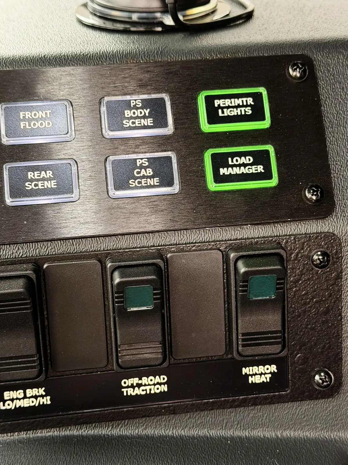 Overhead console close-up showing rocker switches and button row