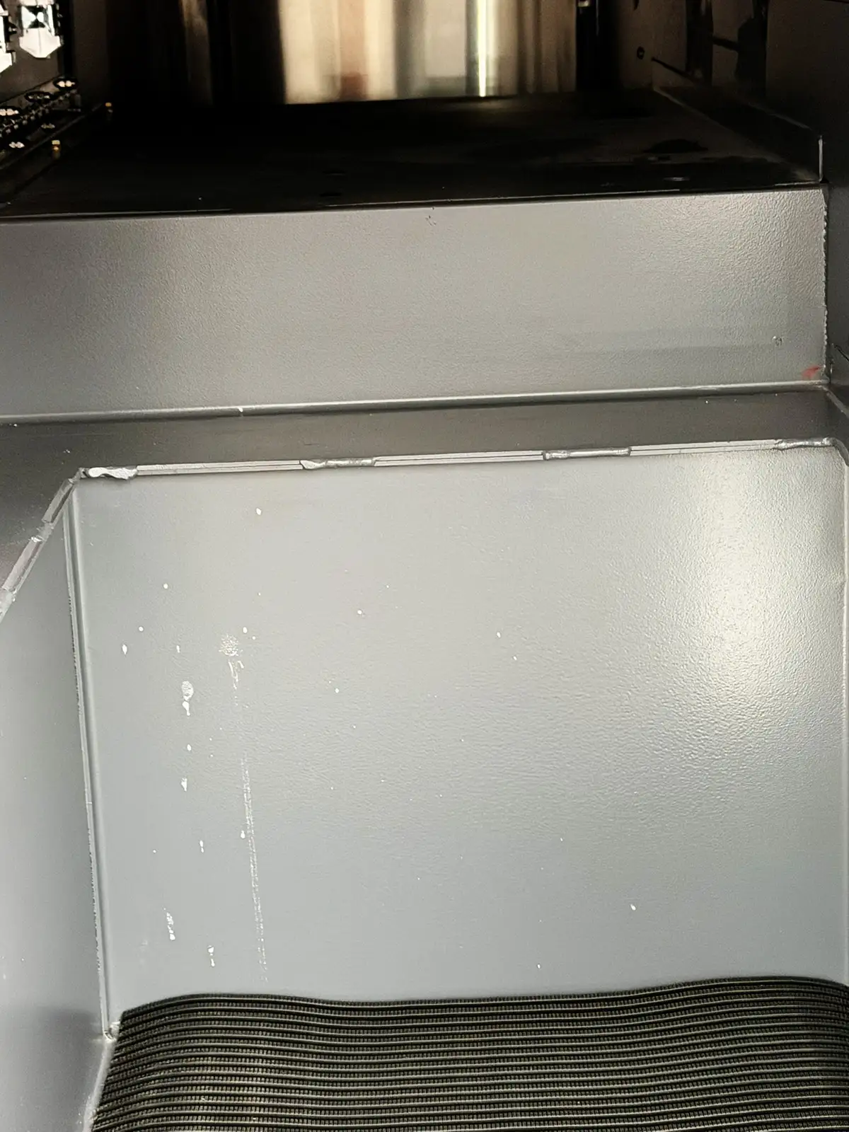 Open side compartment showing mounted hand tools and saw storage