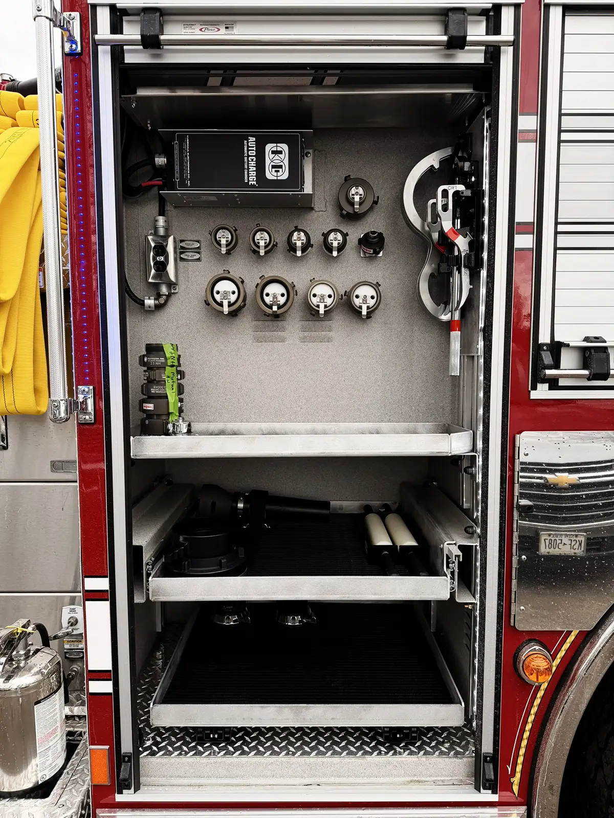 Open side compartment with pull-out tray showing rescue tool storage