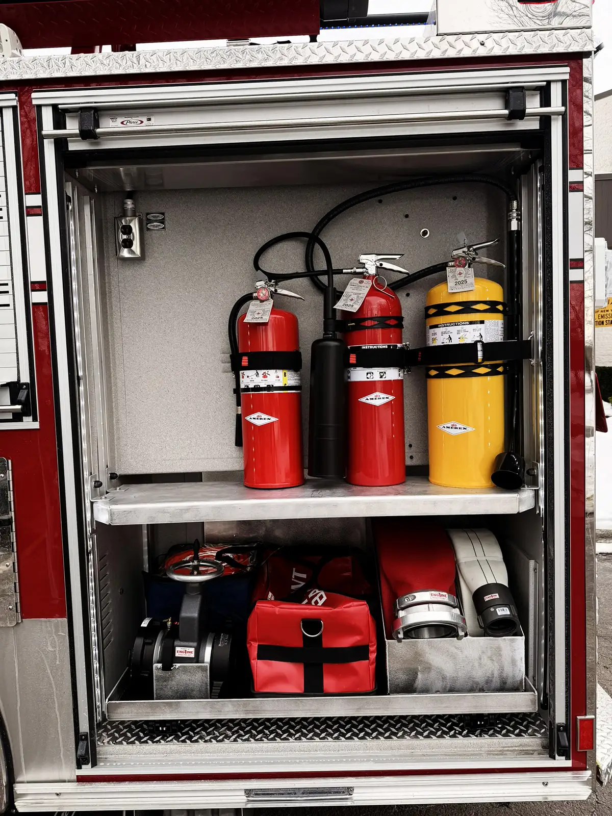 Open side compartment showing mounted rescue tools and lower equipment shelf