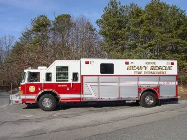 Driver-side profile view showing rescue body compartments and side lettering