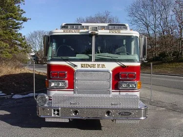 Head-on front view showing grille, bumper, and warning lights
