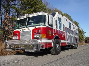 Heavy rescue truck front-left exterior view with ladder rack visible on roof