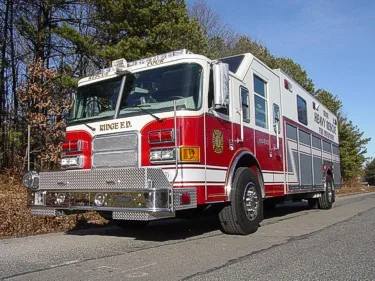 Heavy rescue truck front-left exterior view showing cab and side compartments