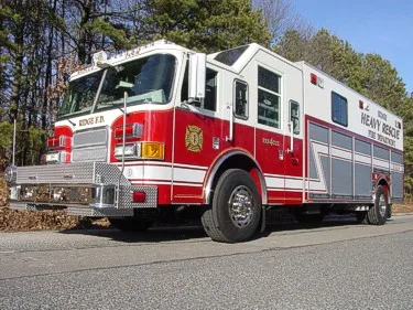 Heavy rescue truck front-left profile showing crew cab and long body