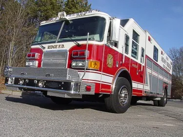 Heavy rescue truck front-left exterior view showing cab and side panel lettering