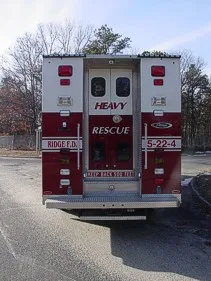 Rear view showing dual rear doors, chevrons, and upper warning lights